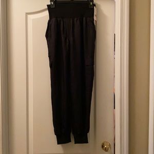 Shiny black cargo joggers.